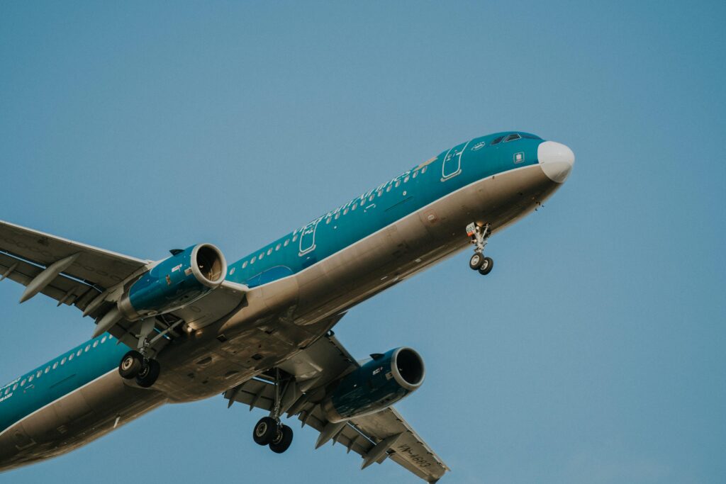 A Vietnam Airlines passenger airplane in flight, clear blue sky backdrop.