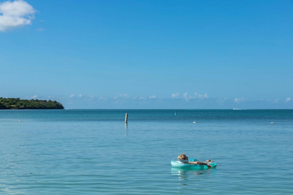 A tranquil scene of a woman relaxing on a float in the beautiful turquoise waters of Cabo Rojo, Puerto Rico.