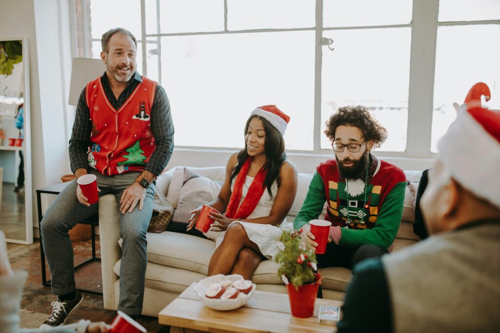 A group of colleagues enjoying a festive office Christmas party with holiday decor.