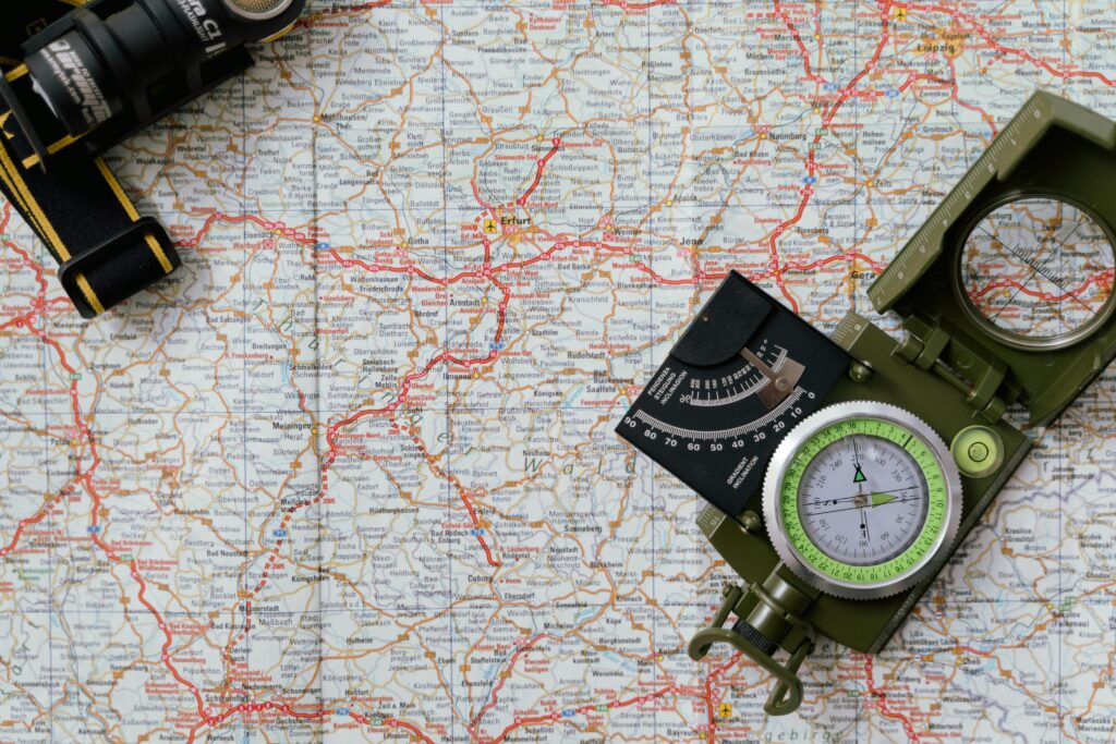 Close-up view of a compass on a detailed map, ideal for travel and navigation concepts.